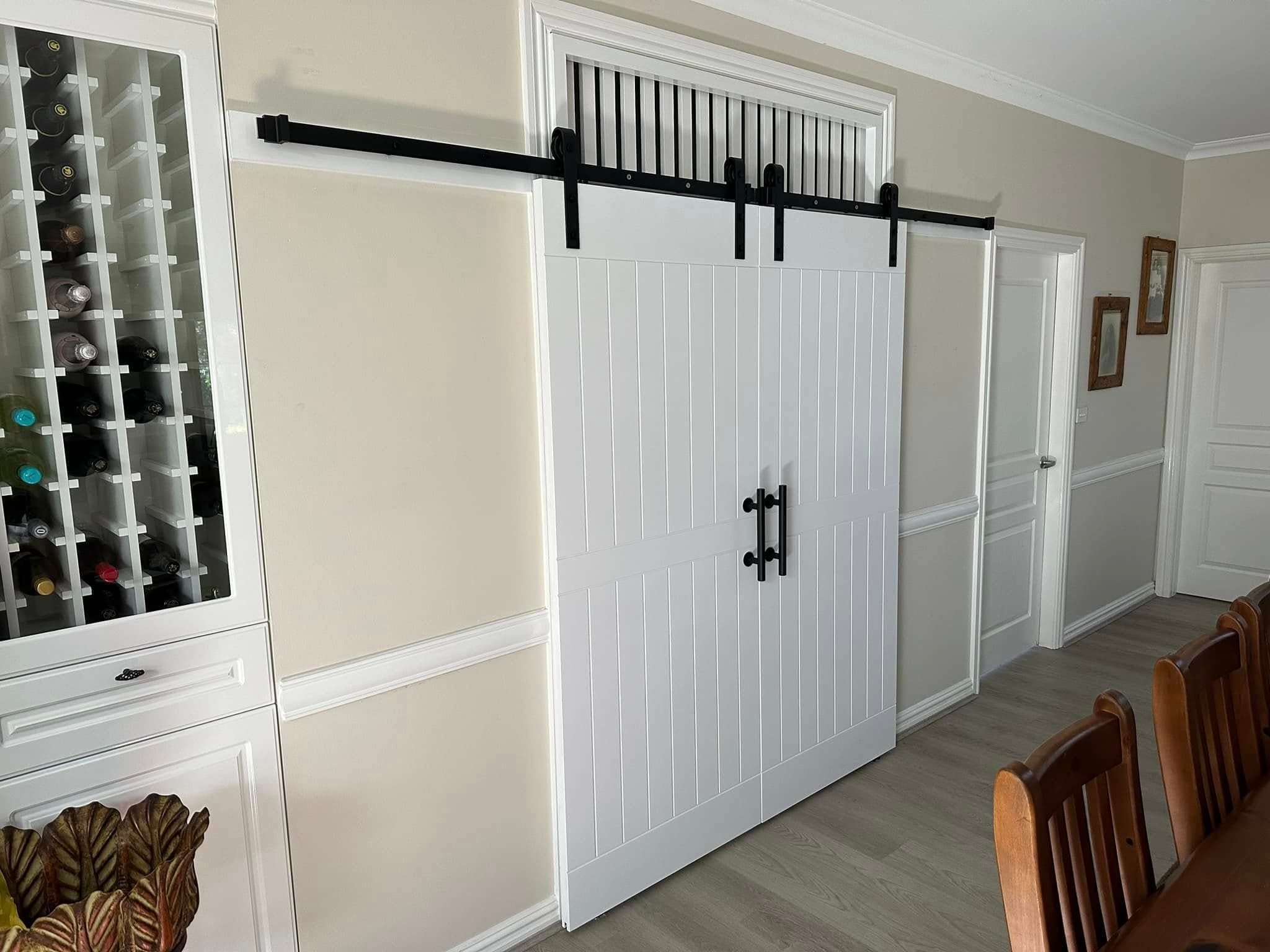 White sliding barn doors with wine cellar