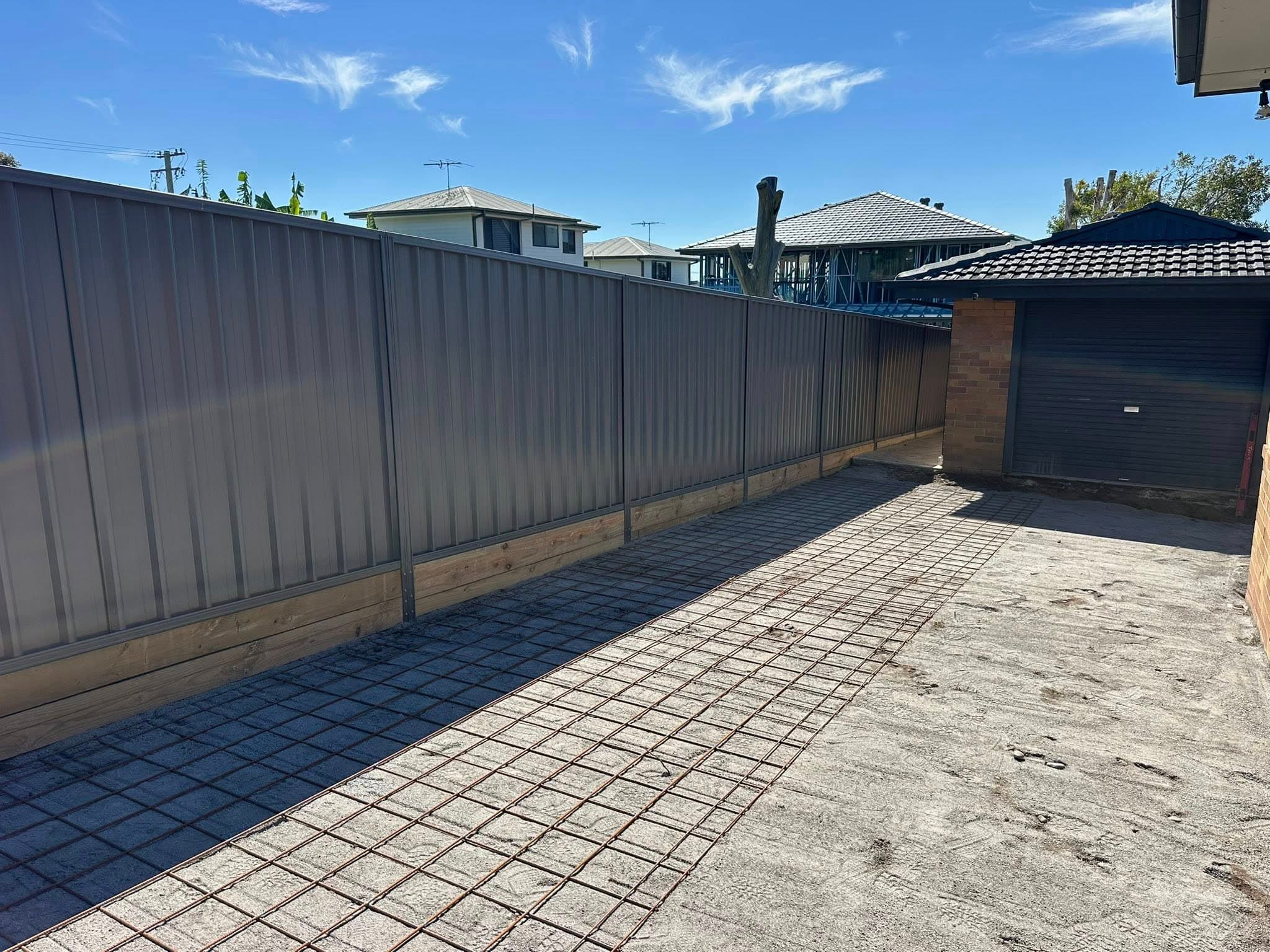 Colourbond fence install — fresh boundary line + concrete prep