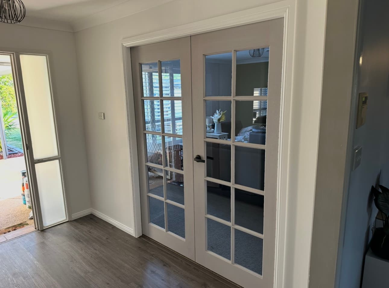 Glazed French doors — 10-lite double doors off the entry hall