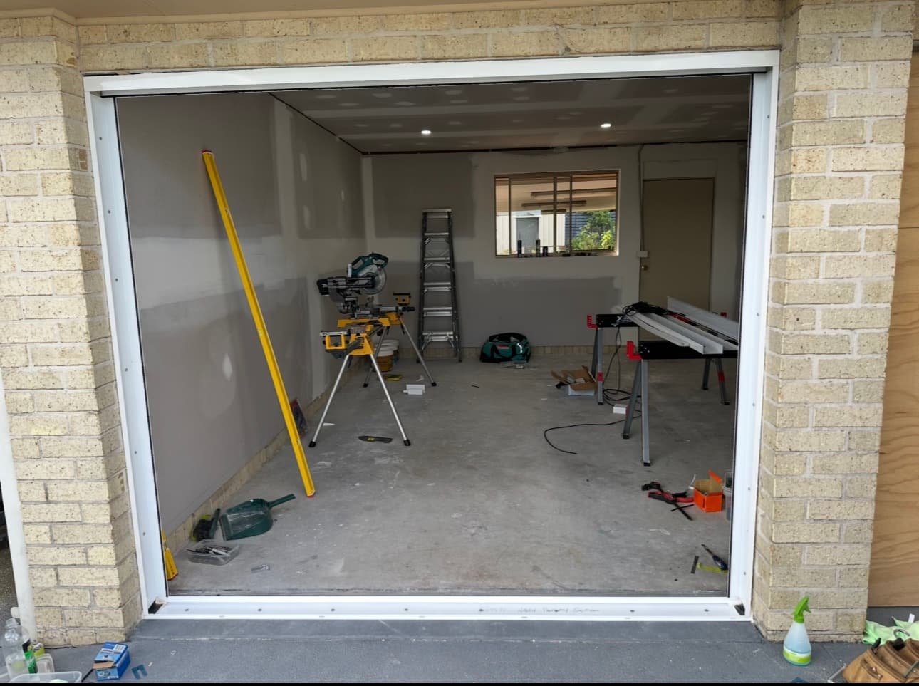 Garage conversion — before: garage opening framed up